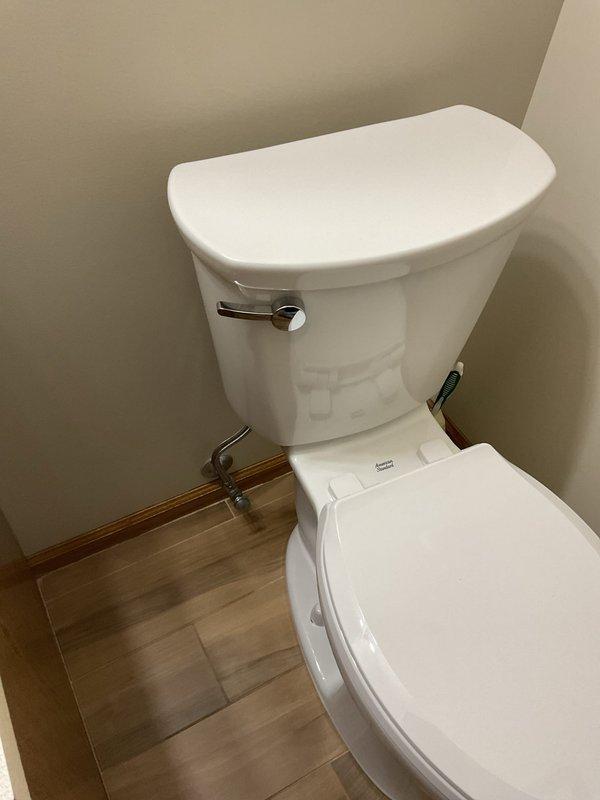 Completed warranty toilet replacement in customer's bathroom. Installed standard white ceramic toilet with chrome flush handle and connected to existing copper water supply line. Also assessed constantly dripping shower issue and provided recommendations.