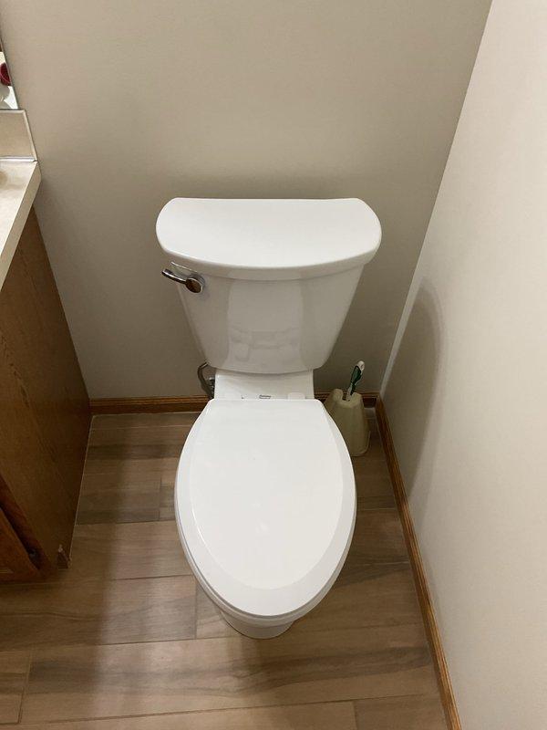 Completed warranty toilet replacement in customer's bathroom. Installed standard white ceramic toilet with chrome flush handle and connected to existing copper water supply line. Also assessed constantly dripping shower issue and provided recommendations.