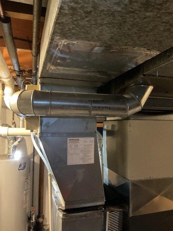 Performed annual maintenance on 9-year-old EnergiAir furnace system (warranty expires 01-2027). Inspected ductwork including seasonal dampers marked "SUMMER"/"WINTER" and verified proper humidifier operation. Completed standard tune-up procedures on furnace with last comprehensive maintenance documented in 2021. Noted client has active home warranty coverage.