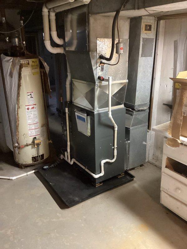 Successfully installed new furnace in basement utility room. Unit was properly connected to existing ductwork with new PVC venting system. System was mounted on protective pad and all connections were verified for proper operation.