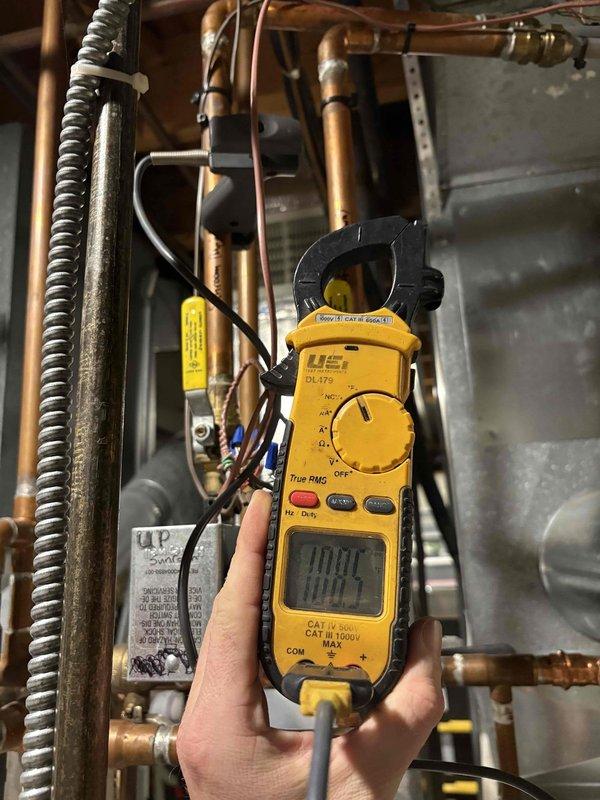 Diagnosed electrical issues with in-floor heating system in sun porch. Performed amperage testing with UEi DL479 clamp meter, obtaining readings of 1.00A and 180.7A on the Bradford White system components. Verified proper electrical supply and operation after previous service work.