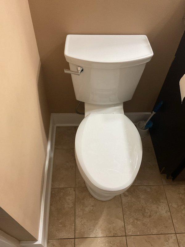 Successfully installed American Standard toilet in corner bathroom location. Properly secured fixture to existing beige ceramic tile flooring and connected to water supply. Final inspection confirmed proper operation with no leaks.
