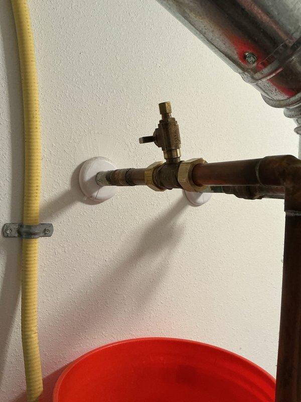 Successfully installed a powered humidifier system connected to the existing HVAC setup, including proper copper pipe installation with a T-junction and control valve. The humidifier was mounted securely and connected to the ductwork with all necessary plumbing components properly secured and tested for operation.