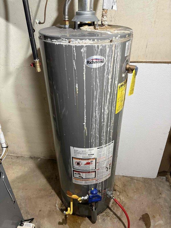 Successfully completed installation of a 40-gallon Richmond natural gas water heater (tall model). Replaced aging unit that showed significant mineral deposits and wear. Connected new system to existing copper plumbing and gas line, ensuring proper venting and all connections were secure and leak-free.