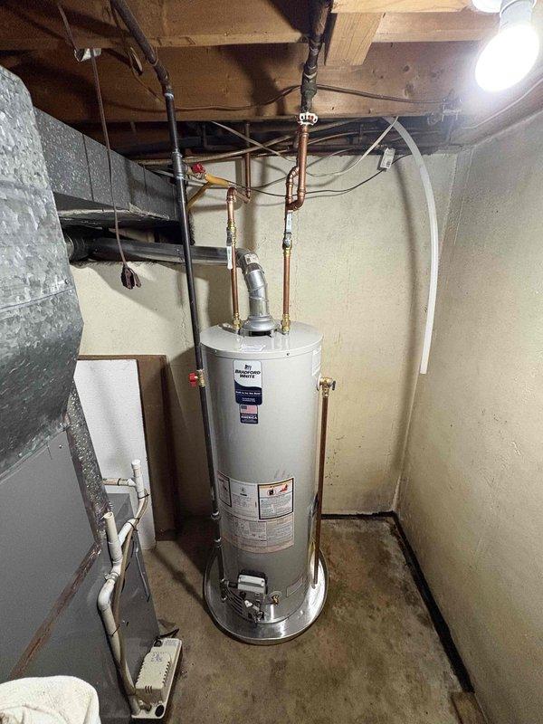 Successfully completed installation of a 40-gallon Richmond natural gas water heater (tall model). Replaced aging unit that showed significant mineral deposits and wear. Connected new system to existing copper plumbing and gas line, ensuring proper venting and all connections were secure and leak-free.