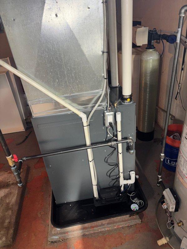 Successfully installed new high-efficiency furnace and water heater in customer's utility room, including proper connection of PVC exhaust venting and all necessary electrical components. System was mounted on appropriate drip pan and platform, with all connections secured and tested for proper operation.