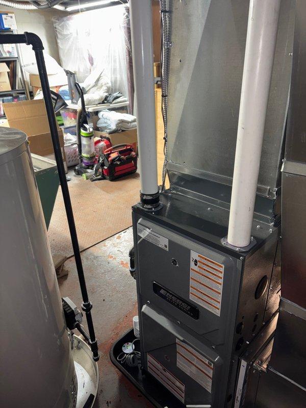 Successfully installed new high-efficiency furnace and water heater in customer's utility room, including proper connection of PVC exhaust venting and all necessary electrical components. System was mounted on appropriate drip pan and platform, with all connections secured and tested for proper operation.