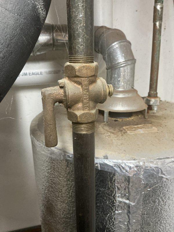 Investigated odor complaint from water heater in furnace room. Inspected 5-year-old furnace system, water heater connections, and associated plumbing components including brass valve assembly. System was found to be operating normally with no gas leaks detected; recommended routine maintenance to prevent future issues.