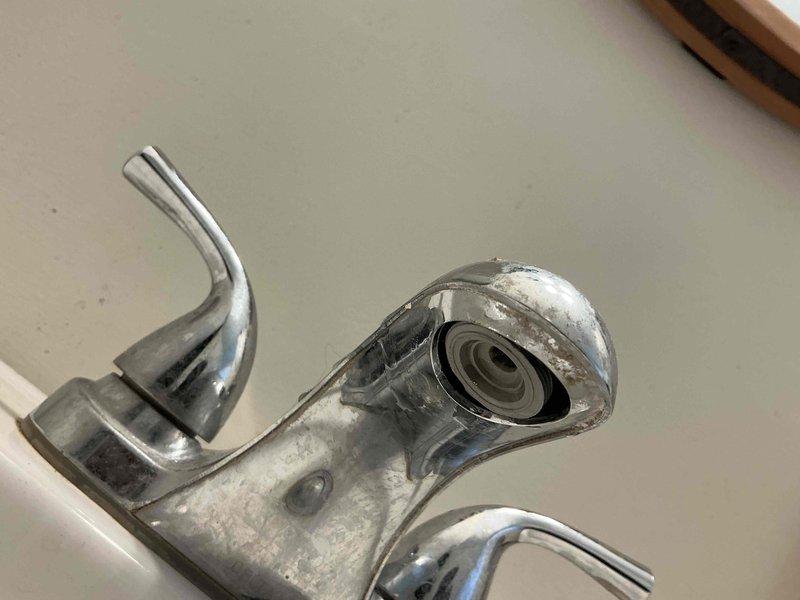 Responded to service call for leaking bathroom pedestal sink reported to have started the day of service. Upon inspection, identified mineral buildup on chrome faucet contributing to leak. Repaired leak by replacing worn components and clearing calcium deposits from affected areas, restoring proper functionality to the sink.