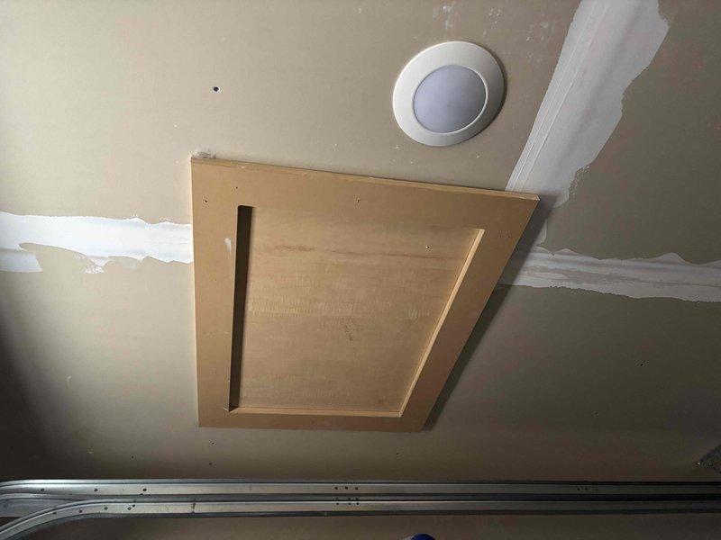 Investigated odor issue in garage apartment with mini-split system. Inspected ceiling-mounted HVAC cassette unit and identified musty smell emanating from condensate drain line. Cleaned drain line and applied antimicrobial treatment to prevent future bacterial growth causing odors. Recommended portable humidifier solution to address customer's concerns about cracking paint and dehydrating wood in the space.