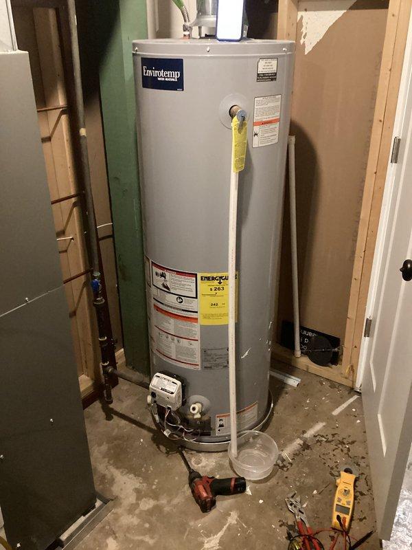 Diagnosed 10-year-old US/Craftmaster water heater that was not lighting. Inspected gas control valve and thermocouple, finding significant corrosion and mineral buildup affecting ignition system. Cleaned connections, replaced thermocouple, and verified proper operation after repair with successful ignition and consistent flame.