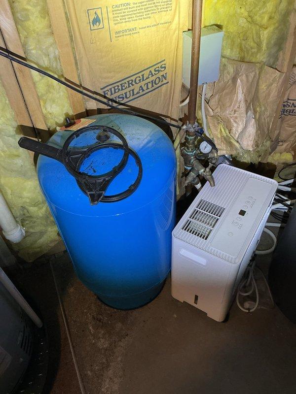 Responded to basement flooding caused by floor drain backup. Inspected plumbing system, including water pressure tank and associated piping in utility area. Cleared main drain line obstruction using professional equipment, restoring proper drainage function and preventing further water intrusion.