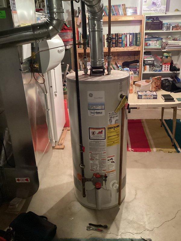 Diagnosed 12-year-old water heater that was not producing hot water; found faulty thermocouple and replaced it, restoring proper ignition and heating functionality. Verified proper venting of exhaust gases through the existing metal ductwork system and confirmed unit was operating within manufacturer specifications after repair.