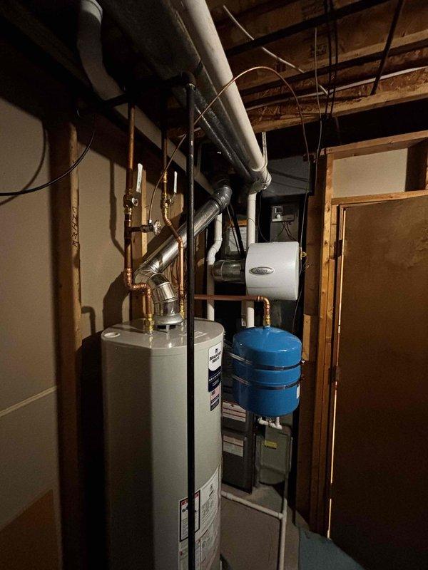 Successfully installed a 40-gallon natural gas water heater (6-year warranty, short model) with expansion tank in residential mechanical room. Completed all necessary copper pipe connections and ensured proper integration with existing plumbing system. Final inspection confirmed proper operation with no leaks or safety issues.