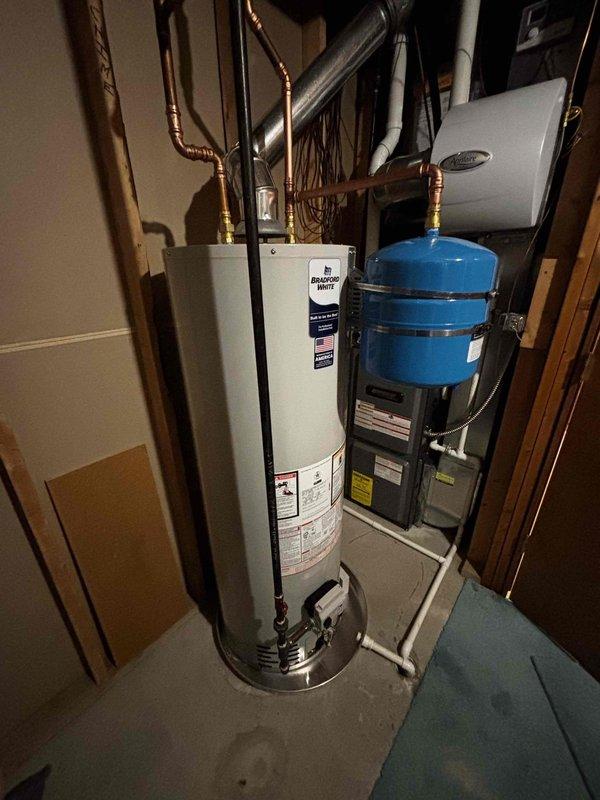 Successfully installed a 40-gallon natural gas water heater (6-year warranty, short model) with expansion tank in residential mechanical room. Completed all necessary copper pipe connections and ensured proper integration with existing plumbing system. Final inspection confirmed proper operation with no leaks or safety issues.