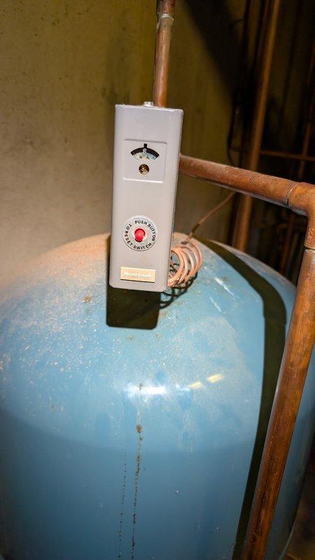 Repaired 29-year-old Burnham boiler that was preventing hot water supply since previous service visit. Inspection revealed damaged control device/temperature gauge on copper piping and deteriorated electrical connections at the main unit. Replaced thermostat assembly and rewired electrical components to restore proper hot water function.