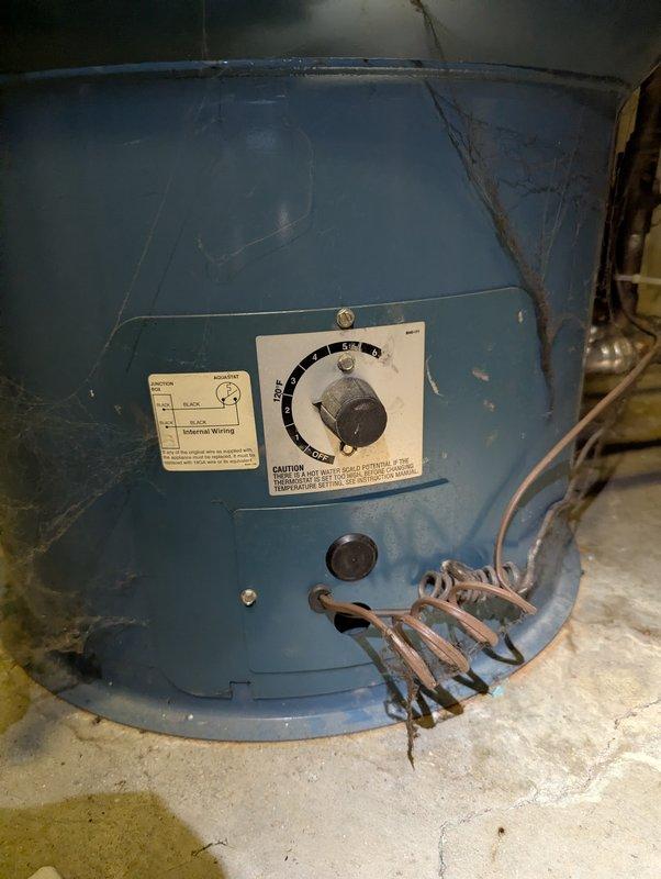 Repaired 29-year-old Burnham boiler that was preventing hot water supply since previous service visit. Inspection revealed damaged control device/temperature gauge on copper piping and deteriorated electrical connections at the main unit. Replaced thermostat assembly and rewired electrical components to restore proper hot water function.