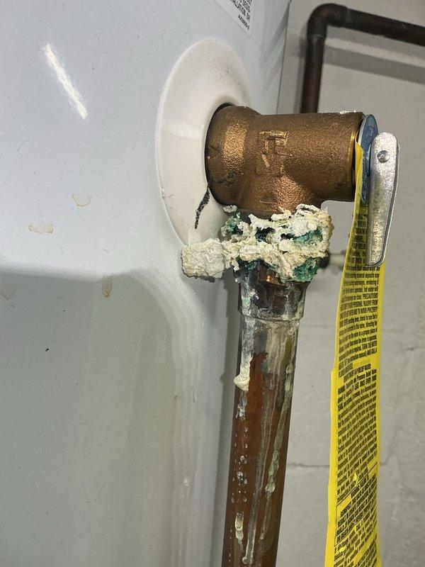 Performed annual heating tune-up on 9-year-old Luxaire furnace for Comfort Club member. Observed significant corrosion and mineral buildup on copper pipe connection to water heater with deteriorated sealing material. Noted yellow gas line and metal piping installation in crawlspace between floor joists requiring attention.