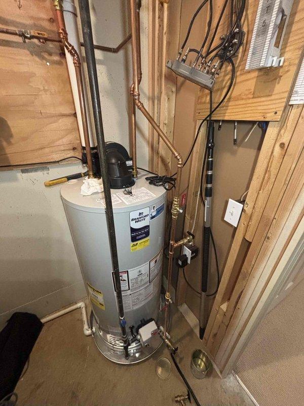 Responded to service call for water heater leaking from valve. Diagnosed issue with brass fitting connection on copper pipe and used pipe wrench to tighten/replace the faulty valve, successfully resolving the leak.