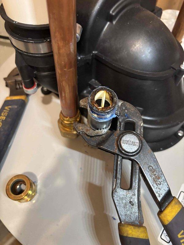 Responded to service call for water heater leaking from valve. Diagnosed issue with brass fitting connection on copper pipe and used pipe wrench to tighten/replace the faulty valve, successfully resolving the leak.