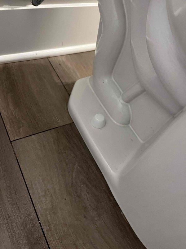Returned to complete quoted toilet repair service. Inspected toilet mounting system and connection to floor. Verified proper installation of plumbing supply lines (PVC, red and blue pipes) secured with appropriate brackets against OSB wall structure.