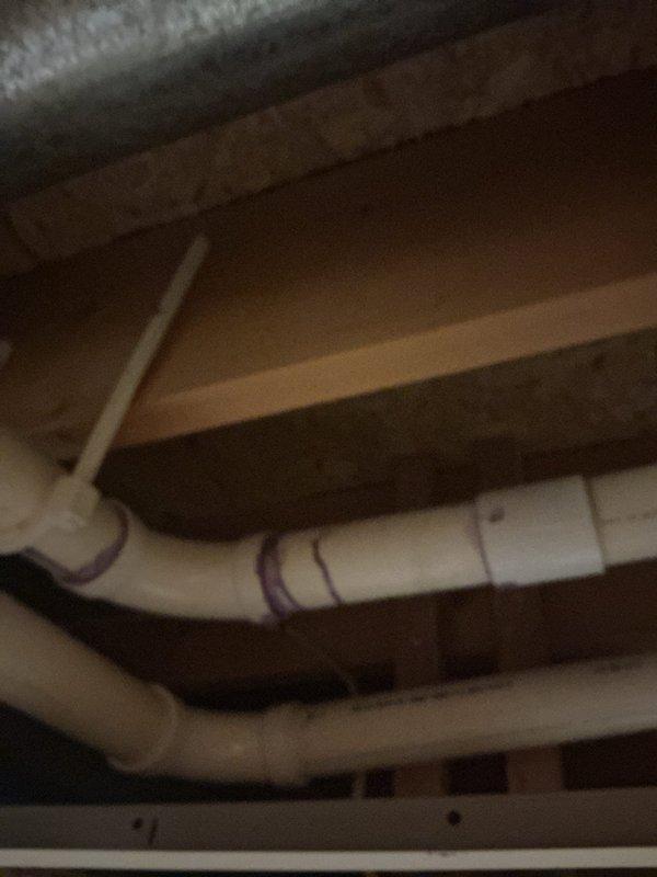 Completed exhaust repairs involving PVC piping in crawlspace/ceiling area. Installed new pipe sections with proper PVC primer/adhesive at connection points. Ensured proper routing of drainage system through structural joists with appropriate supports and connections.