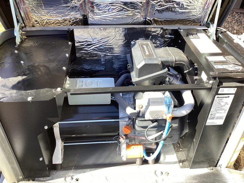 Performed scheduled 2-year tune-up on Honeywell WT 09-2033 generator. Inspected interior components including motor assembly, control module, and ventilation system. Replaced fuel filter (dated 03/19/22) and verified proper connection of all hoses and wiring, with special attention to the blue fuel line integrity.