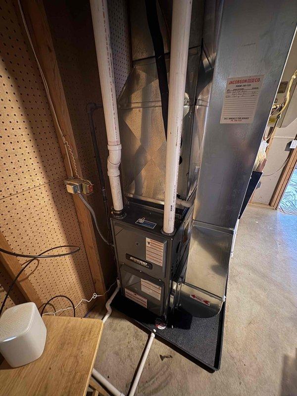 Successfully completed installation of new furnace unit in utility area, including proper connection of PVC ventilation pipes and ductwork components. System was fully tested and is operating at optimal efficiency with all mechanical connections secured and drainage properly configured.