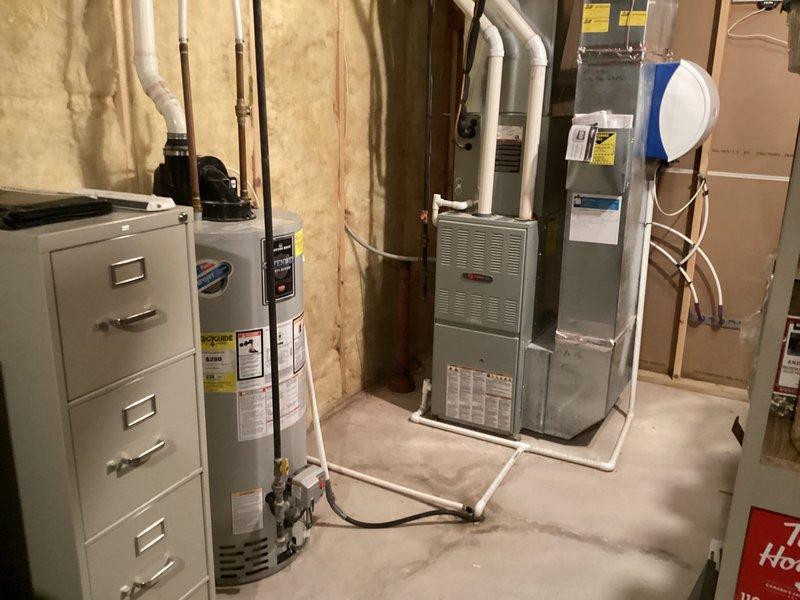 Completed water heater replacement estimate for customer with existing aging unit in basement utility area. Documented current installation configuration including venting, connections, and available space for proper sizing recommendations. Customer requested furnace tune-up service if time permitted; noted this requirement for scheduling purposes.