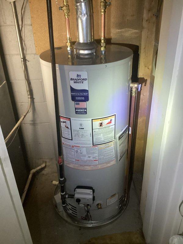 Successfully installed a Bradford White 40-gallon natural gas water heater with 6-year warranty. Connected new copper water lines with appropriate valves and installed metal exhaust flue piping according to code requirements. Unit was properly positioned, secured, and tested for safe operation before completion.