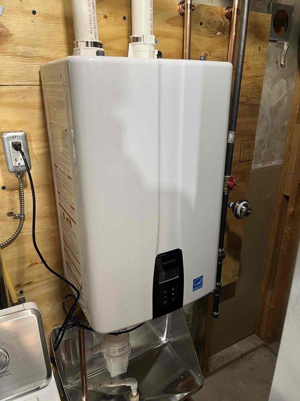 Successfully completed installation of new high-efficiency furnace system and Energy Star rated tankless water heater in utility area. Installed all necessary venting using PVC pipes, connected copper water lines with appropriate valves, and ensured proper electrical connections for both units. All systems were tested and confirmed to be functioning correctly with no leaks or operational issues.