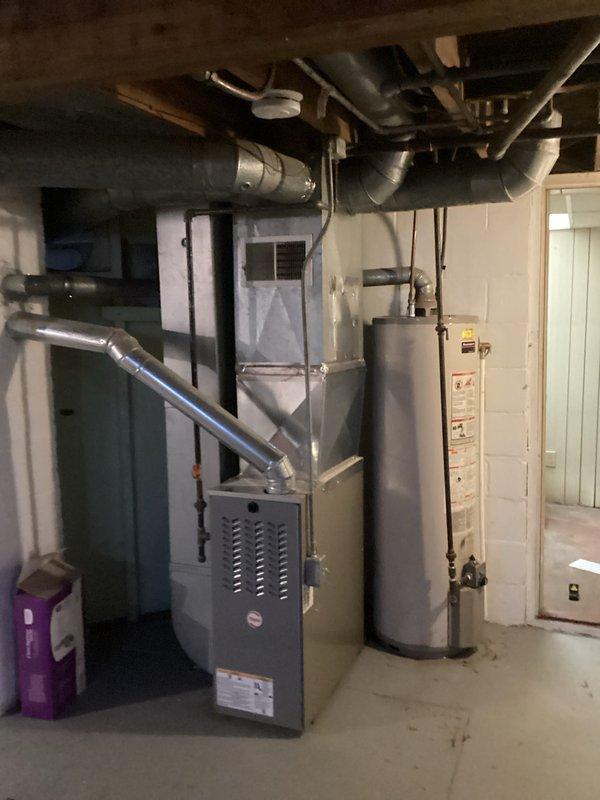 Responded to leak complaint on 10-year-old water heater. Inspection revealed corrosion at pipe joint causing seepage. Replaced damaged section of plumbing and verified proper operation of water heater system.