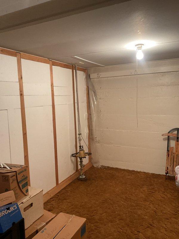 Responded to customer report of basement drain backup. Inspected plumbing system in partially finished basement area, focusing on the brass valve assembly and connected piping. Cleared blockage in drain line and verified proper drainage function before completing service.