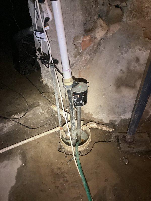 Completed PCI-Plumbing Club Inspection of basement sump pump system and associated discharge piping. Documented functioning sump pump installation with proper PVC discharge configuration and electrical connections. Noted adequately secured horizontal PVC piping in crawlspace with appropriate strapping and verified integrity of nearby utility lines.