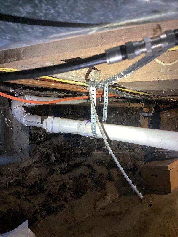 Completed PCI-Plumbing Club Inspection of basement sump pump system and associated discharge piping. Documented functioning sump pump installation with proper PVC discharge configuration and electrical connections. Noted adequately secured horizontal PVC piping in crawlspace with appropriate strapping and verified integrity of nearby utility lines.