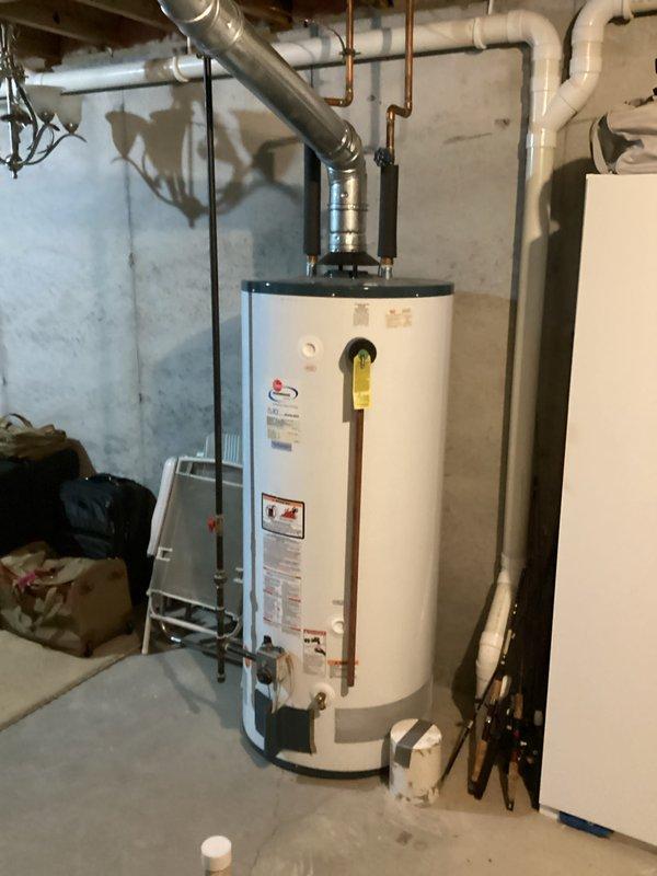 Performed annual heating maintenance on Rheem Guardian System Fury Gas Water Heater (Model 42V75F, manufactured 05/2010). Inspected unit with 75,100 BTU input rating and 80% thermal efficiency, verifying proper operation of all components and connections including copper supply lines and PVC venting system.