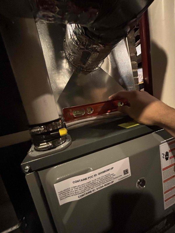 Relocated humidifier to the front of the stand pipe per inspector's correction requirements. Verified proper installation using level measurement and confirmed all connections to HVAC system were secure and operational.