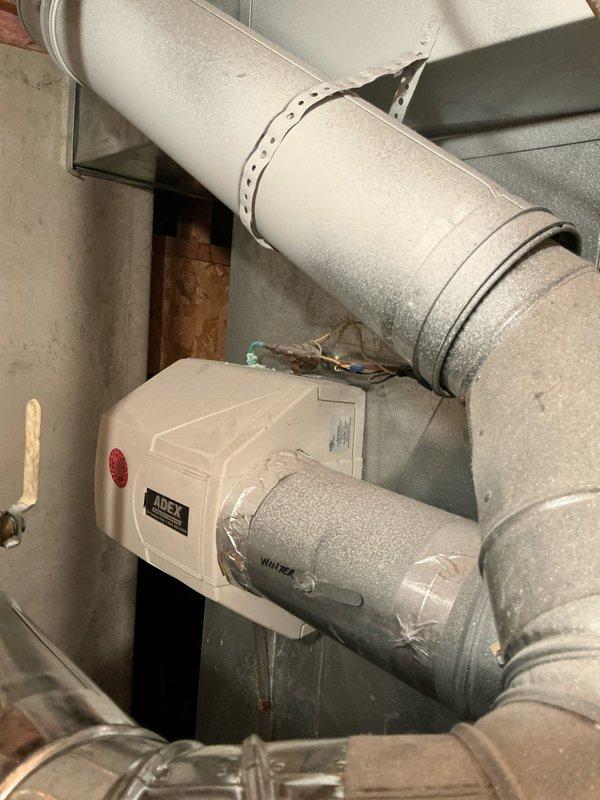 Completed assessment for replacement of 22-year-old HVAC system in single-family residence. Documented existing installation including galvanized ductwork system with APEX humidifier and photographed bedroom with exposed ceiling ductwork and ventilation. Provided estimate for complete furnace and AC replacement based on current system configuration.