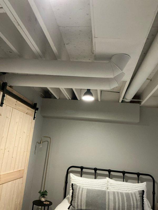 Completed assessment for replacement of 22-year-old HVAC system in single-family residence. Documented existing installation including galvanized ductwork system with APEX humidifier and photographed bedroom with exposed ceiling ductwork and ventilation. Provided estimate for complete furnace and AC replacement based on current system configuration.