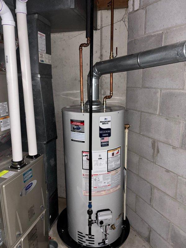 Successfully replaced kitchen faucet and cleared tub blockage using drain rodding equipment. Inspected basement plumbing infrastructure including vertical PVC drain pipe with rusty-brown discoloration and confirmed proper water heater operation with no leaks present.