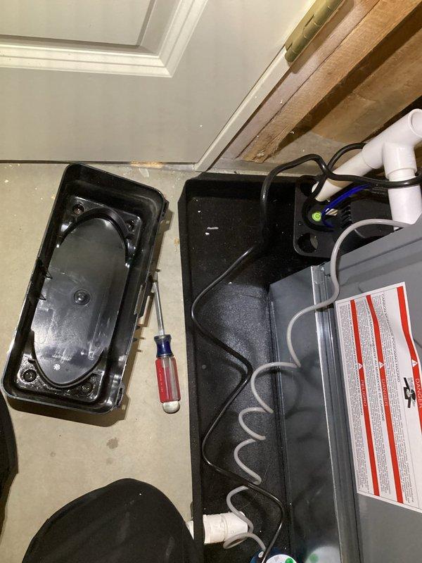 Performed annual furnace and humidifier maintenance in a confined installation space. Inspected electronic control module with blue/white wiring connections and examined connected PVC piping system. Maintenance required accessing equipment with warning labels and various components, with all work successfully completed according to manufacturer specifications.