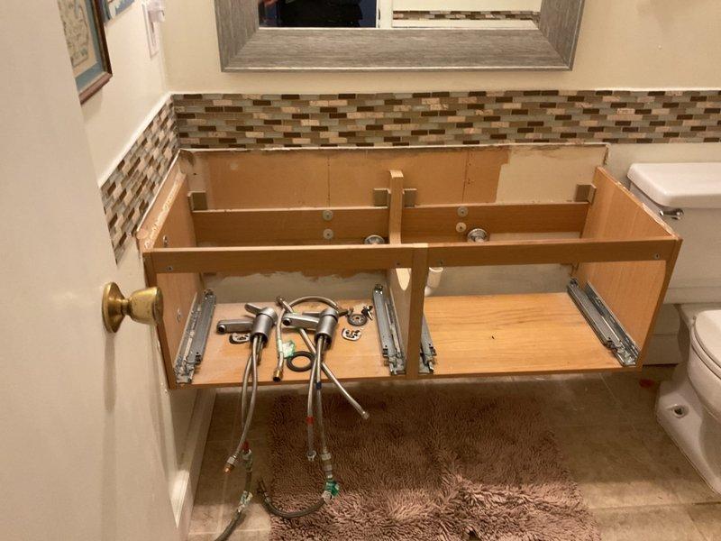 Completed installation of a double bowl sink with new strainers and tubular drain assembly. Assembled and connected all P-trap components and drain piping beneath the bathroom vanity. Work was performed according to quoted specifications and verified proper drainage before completion.