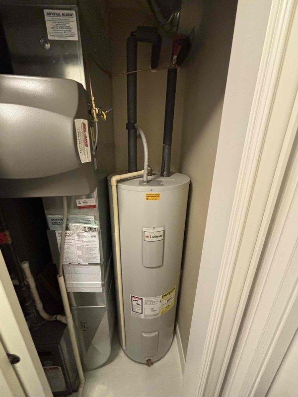 Completed estimate for replacement of a 15-year-old electric water heater with requested Bradford White model RE250T6 50-gallon unit. Inspected current installation in utility closet, noting existing plumbing configuration with black insulated pipes and pressure relief valve drainage. Current unit is functioning but at end of expected service life.