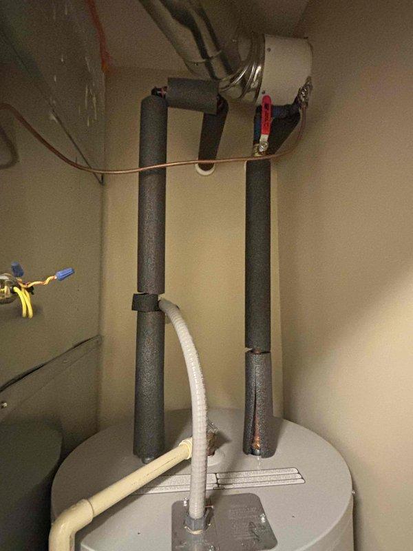 Completed estimate for replacement of a 15-year-old electric water heater with requested Bradford White model RE250T6 50-gallon unit. Inspected current installation in utility closet, noting existing plumbing configuration with black insulated pipes and pressure relief valve drainage. Current unit is functioning but at end of expected service life.