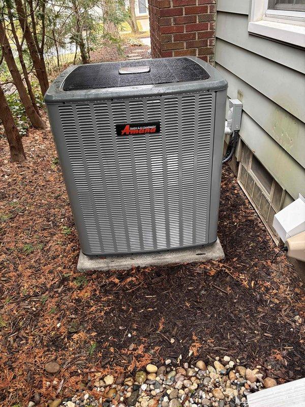 Performed annual heating maintenance on Amana HVAC system. Inspected outdoor condenser unit which is properly installed on concrete pad with adequate clearance. System is operational with no visible damage or deterioration noted.