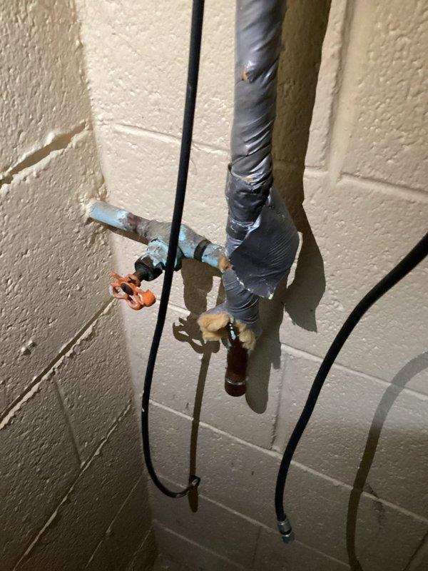 Replaced deteriorated outdoor spigot on concrete block wall exhibiting significant leakage. Installed new quarter-turn valve with blue butterfly handle, ensuring proper connection to existing PVC supply line. System tested with no leaks and full functionality restored.