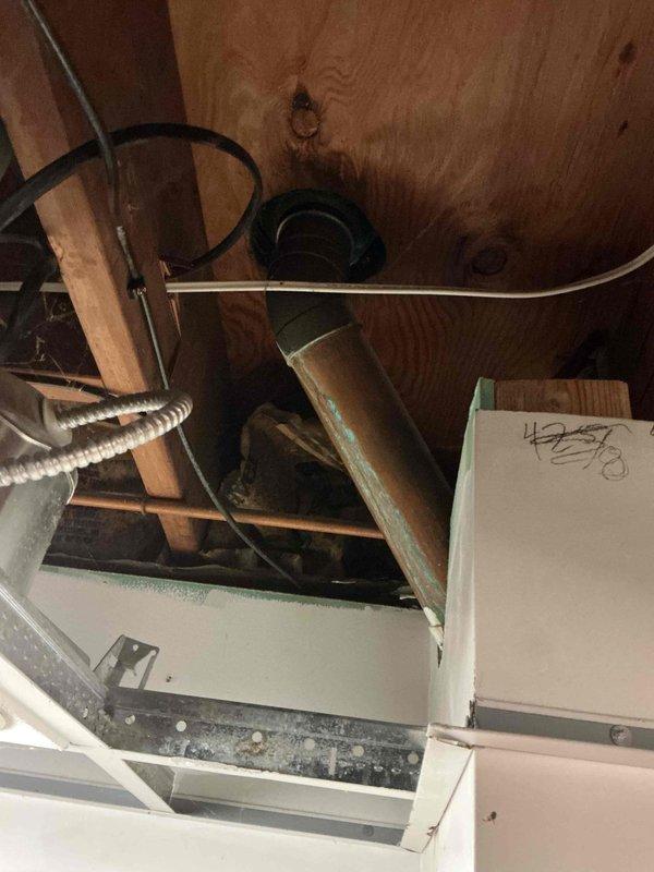 Conducted thorough inspection of residential plumbing system, documenting copper pipe corrosion at multiple junction points in basement area against concrete block wall. Identified potential leak risk in horizontal copper supply line running through ceiling joists, which showed significant discoloration and deterioration requiring immediate attention to prevent future water damage.