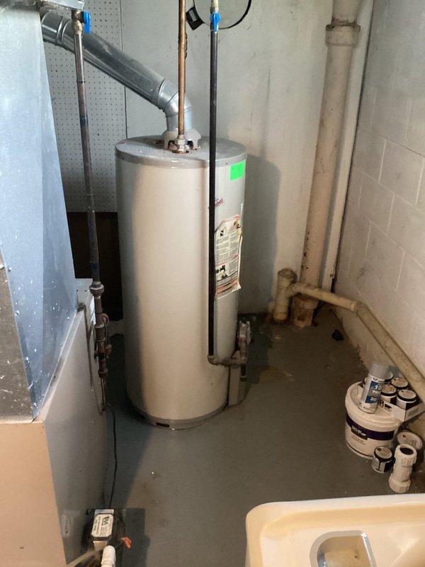 Completed water heater estimate for customer experiencing leakage from existing unit. Inspected current installation including ventilation system, noting damaged wall surface around exhaust piping and examining all plumbing connections. Documented condition of existing tank and surrounding utility area to prepare comprehensive replacement options.