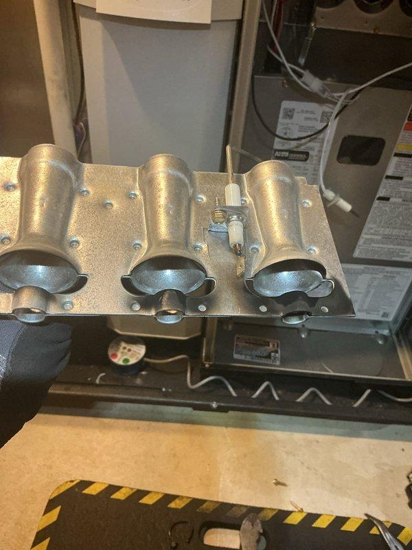 Completed quoted repair of gas furnace by replacing faulty gas valve. Removed burner assembly to access valve, installed new component, and verified proper ignition sequence after installation. System now operating with correct flame pattern across all three burners.