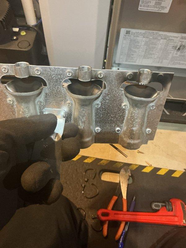 Completed quoted repair of gas furnace by replacing faulty gas valve. Removed burner assembly to access valve, installed new component, and verified proper ignition sequence after installation. System now operating with correct flame pattern across all three burners.